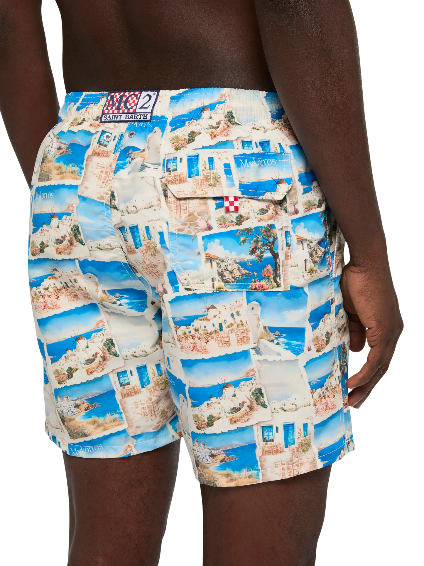 Mid-length Gustavia swim-shorts with Mykonos postcard print | AI CO-CREATED DESIGN BY RICKDICK - POWERED BY RED-EYE