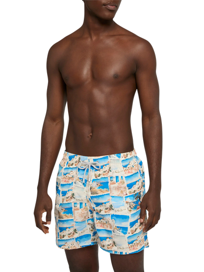 Mid-length Gustavia swim-shorts with Mykonos postcard print | AI CO-CREATED DESIGN BY RICKDICK - POWERED BY RED-EYE